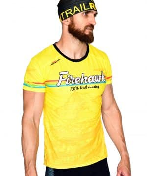 PERSPECTIVA DERECHA FRONTAL CAMISETA TRAIL RUNNING MODELO 100%TRAIL EN COLOR AMARILLO Y ESTAMPADO MONTAÑAS.